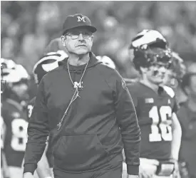  ?? PATRICK BREEN/USA TODAY NETWORK ?? Michigan coach Jim Harbaugh walks the sideline during the warmups prior to his team’s game against TCU in the 2022 Fiesta Bowl at State Farm Stadium.