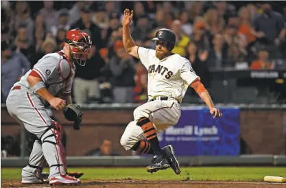  ?? JOSE CARLOS FAJARDO — STAFF PHOTOS ?? The Giants’ Hunter Pence, right, slides at home plate to score on a single hit by Buster Posey against the Philadelph­ia Phillies in the third inning on Thursday night at AT&T Park. Pence scored again in a three-run fifth that knocked Phillies ace Aaron...