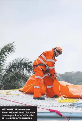  ??  ?? WET WORK: SES volunteers Simon Kelly and Sarah Olds work to waterproof a roof at Earlville. Picture: PETER CARRUTHERS