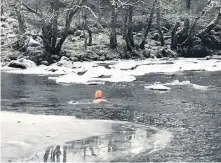  ??  ?? Determined Hilary Williams had to cut through the ice with a pick axe to get into the Linn for her daily swim