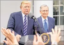  ?? THE ASSOCIATED PRESS ?? Journalist raise their hands as they wait to called on to ask a question to President Donald Trump and Senate Majority Leader Mitch Mcconnell of Ky., in the Rose Garden of the White House in this Oct. 16 file photo.