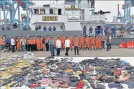  ?? AFP ?? Indonesia's President Joko Widodo (wearing yellow hand gloves) stands in front of recovered debris.