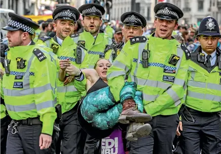  ?? AP ?? Police arrest protesters as they block traffic on London’s Oxford Circus yesterday. The group Extinction Rebellion is calling for a week of civil disobedien­ce against what it says is the failure to tackle the causes of climate change.