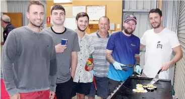  ??  ?? Left: Beyond the Valley directors (from left) Tom Caw, Nick Greco and Christian Serrao chat to Hallora and District Fire Brigade members and barbeque chefs Darren Fowler and Sean Scanlon alongside Beyond the Valley director Mike Christidis.