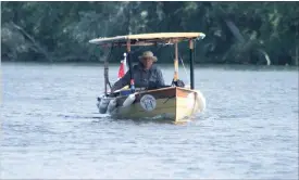  ?? JASON BAIN EXAMINER ?? Phil Boyer guides his solar-powered boat along the Otonabee River near the Bensfort Bridge on Thursday. The Napanee man is making the journey from Trenton to Georgian Bay on the Trent-Severn Waterway.