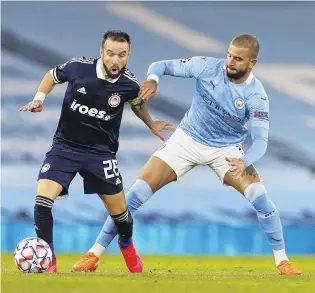  ?? PHOTO: REUTERS ?? Oh no you don’t . . . Olympiacos’ Mathieu Valbuena tries to fend off the challenge of Manchester City’s Kyle Walker during a Champions League Group C match at Etihad Stadium in Manchester yesterday.