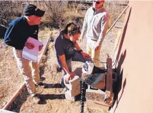  ?? STACY TIMMONS/EL DEFENSOR CHIEFTAIN ?? Scott Christenso­n, left, and Sara Chudnoff of the Bureau of Geology, with Nick Hayes, right, provide training on how to set up equipment for a private domestic well in Monticello, N.M., on Thursday.