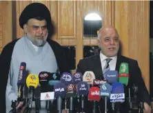  ??  ?? Iraqi Prime Minister Haider Al Abadi, right, and Moqtada Al Sadr announced an alliance last week, in Najaf