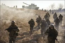  ?? VADIM GHIRDA — THE ASSOCIATED PRESS FILE ?? Ukrainian servicemen of the 3rd Separate Tank Iron Brigade take part in a drill not far from the frontlines in the Kharkiv area of Ukraine on Thursday.