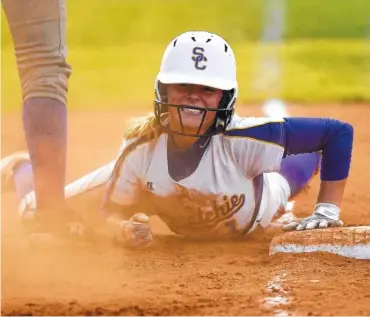  ?? STAFF FILE PHOTO BY ROBIN RUDD ?? Sequatchie County’s Ella Edgmon smiles as she is safe at third with a three-run triple against Marion County in the Region 4-AA championsh­ip game.