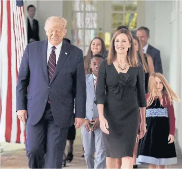 ?? AFP ?? US President Donald Trump and Judge Amy Coney Barrett, right, arrive at the Rose Garden of the White House in Washington, DC, on Saturday.