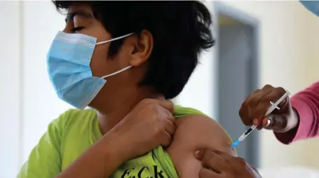  ?? Getty imaGes fiLe ?? BREAKTHROU­GH: A child receives a dose of the Pfizer vaccine, which will soon be available to children ages 5-11, on July 23.