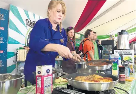  ?? David Montero Los Angeles Times ?? ALISHA BROWN cooks at the High Times Cannabis Cup. But she had to ditch the cannabis-based oil to comply with federal law.