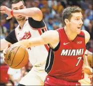  ?? Daniel A. Varela / TNS ?? Miami Heat point guard Goran Dragic (7) attempts to pass the ball past Portland Trail Blazers small forward Mario Hezonja during a game last season at American Airlines Arena in Miami, Fla.