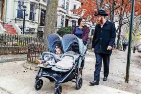  ?? [PHOTO BY ELIYAHU PARYPA, ?? In this Nov. 25 photo provided by Chabad. org, Rabbi Mendel Alperowitz, walks with his wife, Mussie, and daughters in the Brooklyn borough in New York before moving to Sioux Falls, South Dakota.