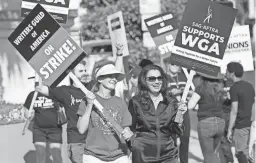  ?? CHRIS PIZZELLO/AP FILE ?? Meredith Stiehm, left, president of Writers Guild of America West, and Fran Drescher, president of the Screen Actors Guild-American Federation of Radio and Television Artists, take part in a rally with striking writers on May 8. Hollywood actors may be on the verge of joining screenwrit­ers in what would be the first two-union strike in the industry in more than six decades.