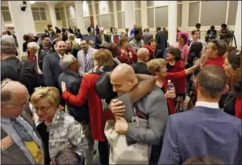  ?? BOB MACK — FLORIDA TIMES-UNION VIA AP ?? In this Tuesday photo, Duval Schools Superinten­dent Nikolai Vitti, center, is hugged after the Jacksonvil­le City Council voted 12-6 to support the Human Rights Ordinance (HRO) in Jacksonvil­le, Fla. At left are Rabbi Rick Shapiro, the Interim Senior...