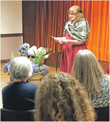  ??  ?? Below: Poetry competitio­n winner Louise Greig performs her winning poem.