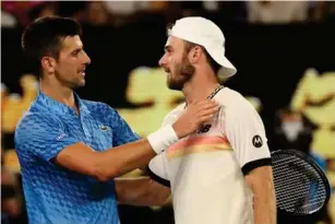  ?? (Getty) ?? Djokovic greets Tommy Paul at the net after winning in straight sets against the American