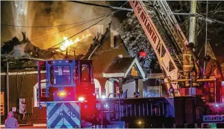  ?? JOHN SPINK / JSPINK@AJC.COM ?? B’s Cracklin’ Barbecue, a beloved eatery in Atlanta’s Riverside neighborho­od, burns Wednesday morning. In 2017, food website Eater named B’s Cracklin’ restaurant of the year in Atlanta.