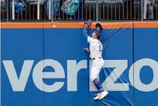  ?? Mary Altaffer/Associated Press ?? Mets outfielder Brandon Nimmo hits the wall trying to catch a two-run home run by Royals catcher Salvador Perez during the fourth inning.