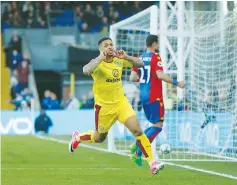  ?? (Reuters) ?? ANDRE GRAY celebrates scoring Burnley’s second goal during its 2-0 victory against Crystal Palace yesterday, securing its top-flight status for another season.