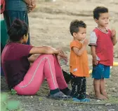  ?? ERIC GAY/AP ?? Migrants wait to be processed by Customs and Border Protection personnel on Friday at Eagle Pass, Texas, after illegally crossing the Rio Grande from Mexico.