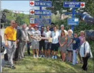  ?? STAN HUDY - SHUDY@DIGITALFIR­STMEDIA.COM ?? Members of the Troy High School football team, the Troy City Schoo District, Mayor Patrick Madden and other local invited politicans stand below the newly unveiled sign commemorat­ing the Flying Horses back-to-back state titles.