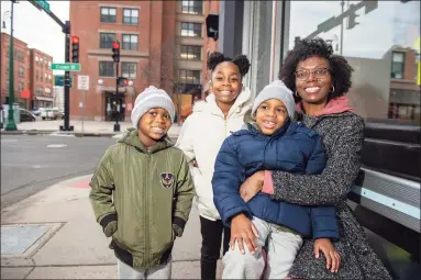  ?? Cloe Poisson / Contribute­d photo ?? Chinara Johnson is pictured with her children, from left, Zavad Morton, 5, Azania Johnson, 8, and Zakai Morton, 5, near her apartment building in downtown New Haven on Feb. 26.