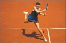  ?? Cameron Spencer / Getty Images ?? Maria Sharapova plays a forehand during her match against Karolina Pliskova at the French Open on Saturday.