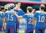  ?? Tony Avelar Associated Press ?? WAMBACH, center, scored 184 goals in internatio­nal competitio­n, the most of any player in history.