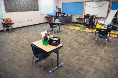  ?? EDDIE MOORE/JOURNAL ?? Desks in a first grade classroom at El Camino Real Academy in Santa Fe are spaced 9 feet apart in October to help prevent the spread of COVID-19. Some students in Santa Fe returned to school under the hybrid model in the fall.