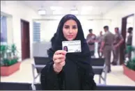  ?? SAUDI INFORMATIO­N MINISTRY VIA AP ?? Esraa Albuti displays her driver’s license in Riyadh, Saudi Arabia, on Monday. The country has issued the first driver’s licenses to 10 women.