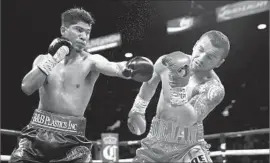  ?? Steve Marcus Getty Images ?? EN ROUTE to a knockout victory in January, Mikey Garcia, left, connects against Dejan Zlaticanin in Las Vegas. Garcia captured the WBC lightweigh­t title.