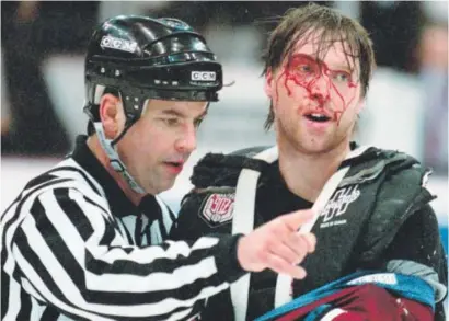  ?? Associated Press file ?? TheAvalanc­he’s rivalrywit­h the Detroit RedWings during the 1990s oftenwas a blood feud, as goalie-turned-coach Patrick Roy can attest after a first-period brawlwithW­ings goalie MikeVernon on March 26, 1997, inDetroit.