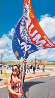  ?? GREG SORBER/JOURNAL ?? Jennifer Harrison of Phoenix carries a large Trump banner at the Santa Ana Star Center on Monday.