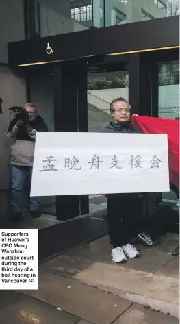 ?? AP ?? Supporters of Huawei’s CFO Meng Wanzhou outside court during the third day of a bail hearing in Vancouver