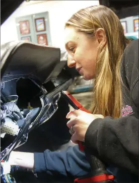  ?? DANIELLE RAY / SENTINEL & ENTERPRISE ?? Champion drag racer Britt Taylor works on a 1968 Ford Mustang for a shop customer at Renegades Rides in Fitchburg, her racing team's home base