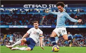  ?? AFP PIC ?? Manchester City’s Leroy Sane (right) crosses the ball as Bournemout­h’s Simon Francis tries to block in their Premier League match at the Etihad Stadium on Saturday.