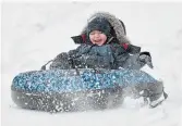  ?? BARRY GRAY THE HAMILTON SPECTATOR ?? Four-and-a-half-year-old Tristen has a laugh sliding down the hill at Chedoke Golf Course.