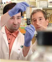  ??  ?? UNBC biochemist­ry professor Stephen Rader, right, works with graduate student Corbin Blank in 2016.