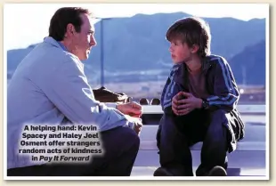  ??  ?? A helping hand: Kevin Spacey and Haley Joel Osment offer strangers random acts of kindness in Pay It Forward