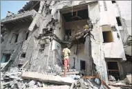  ?? ABDULJABBA­R ZEYAD / REUTERS ?? A boy looks at a damaged house at the site of a Saudi-led airstrike in Hodeidah, Yemen, on Thursday.