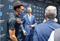  ?? Ethan Hyman/The News & Observer via AP ?? ■ Jon Scheyer, center, laughs while talking with Wendell Moore Jr. after an NCAA basketball press conference Friday at Cameron Indoor Stadium in Durham, North Carolina. Scheyer will spend the upcoming year as associate head coach as coach Mike Krzyzewski chases one more championsh­ip. Then it’s up to Scheyer to take over in the program’s first coaching change in more than four decades.