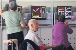  ?? LU QIJIAN / FOR CHINA DAILY ?? Investors monitor stock prices at a brokerage in Fuyang, Anhui province.