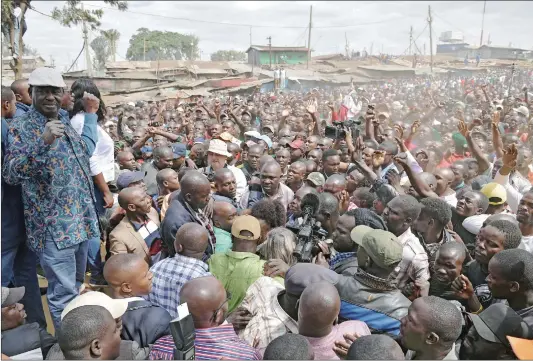  ?? Photo: AFP ?? Kenya’s opposition leader Raila Odinga ( left) speaks on Sunday in the Kibera district of Nairobi. He urged his supporters to boycott work, promising to announce on Tuesday his strategy after an election he claims was stolen from him.