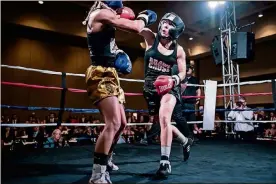  ?? CONTRIBUTE­D BY RANDMC PHOTOGRAPH­Y ?? Erica Rodriguez (right) participat­ed in the boxing charity event Brawl for a Cause in April. She hoped that purse money could pay for her daughter’s medical expenses. Although she lost the fight, she continues to box.