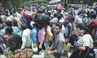  ?? MONEY SHARMA / AGENCE FRANCE-PRESSE ?? Migrant workers and their families queue for a medical screening during a lockdown to fight the spread of COVID-19 in New Delhi, India, on Monday.