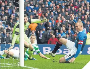  ??  ?? ■ Kenny Miller slides home the opener for Rangers at Ibrox.