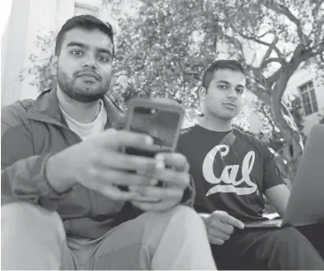  ?? LAURA A. ODA/STAFF ?? Junior Rohan Pai, left, and Ash Bhat, a sophomore at UC Berkeley, have created the Presidenti­al Actions app. “One of the big things that we can do is just educate people and let them come to their own decisions,” said Bhat.